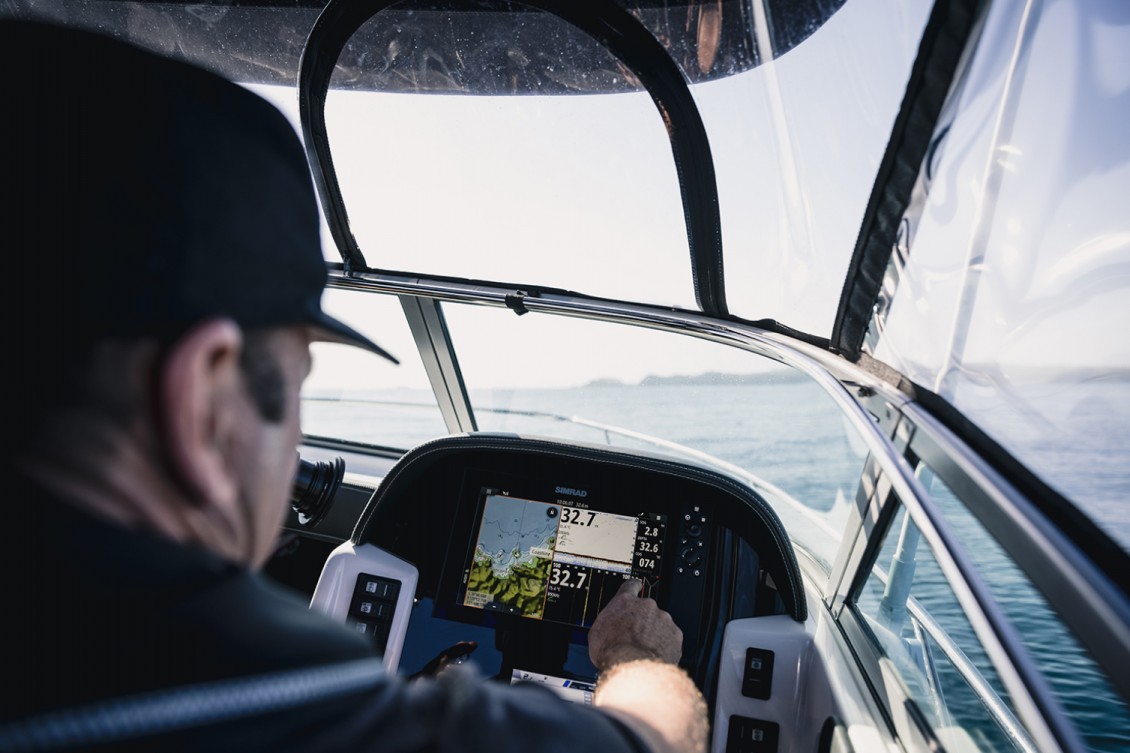 Simrad touch-screen electronics inset into the dash. Gauges and switches within easy reach. | REDHOT Marine